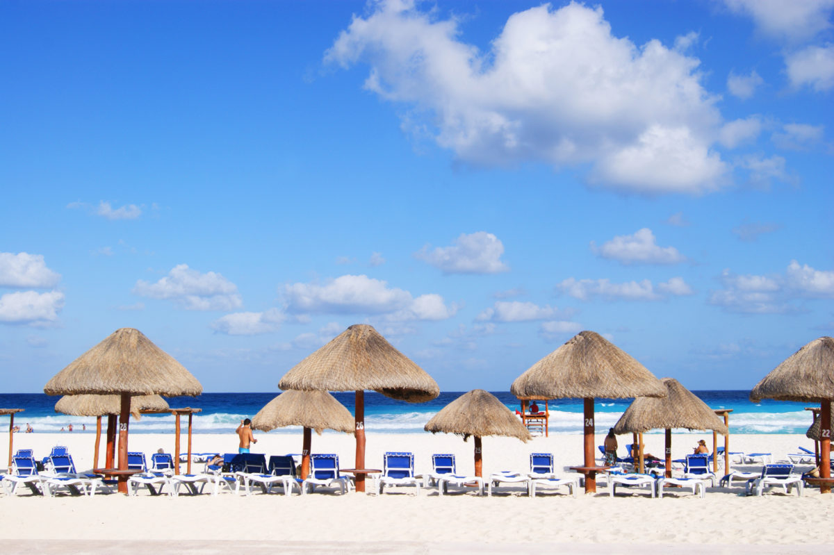 Cancun resort with beach beds and umbrellas